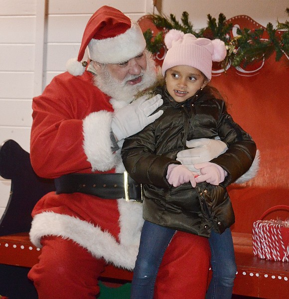 Kristal Cooke, a 5-year-old Park Avenue Elementary School student, is one of the first to share her wishes with Santa Claus, played by Charlie Sacco.      