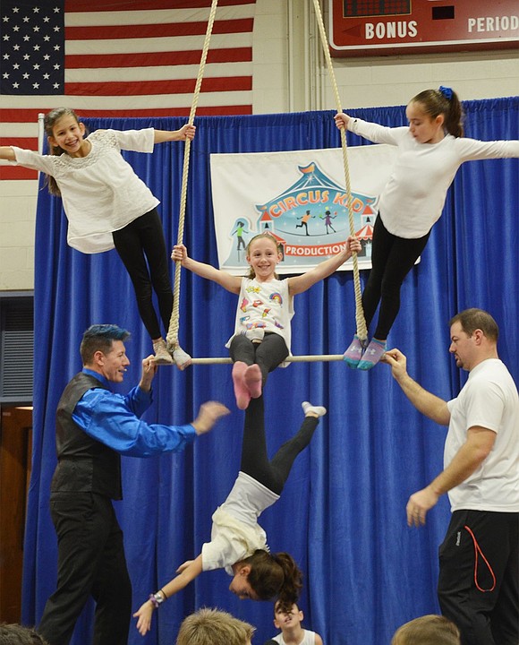 In a more complicated pose, Abby Coffey (top left), Emma Yaches and Lexis Music balance on the trapeze while Maddie Margolis hangs upside down from Yaches’ legs at Blind Brook's annual fourth-grade Blue Bird Circus at B.M.P Ridge Street Elementary School on Friday, Dec. 8. They were assisted by Doug Young with Circus Kids Productions and Steve Forzaglia, a Blind Brook physical education teacher. This was the first year trapeze acts were featured at the circus. 