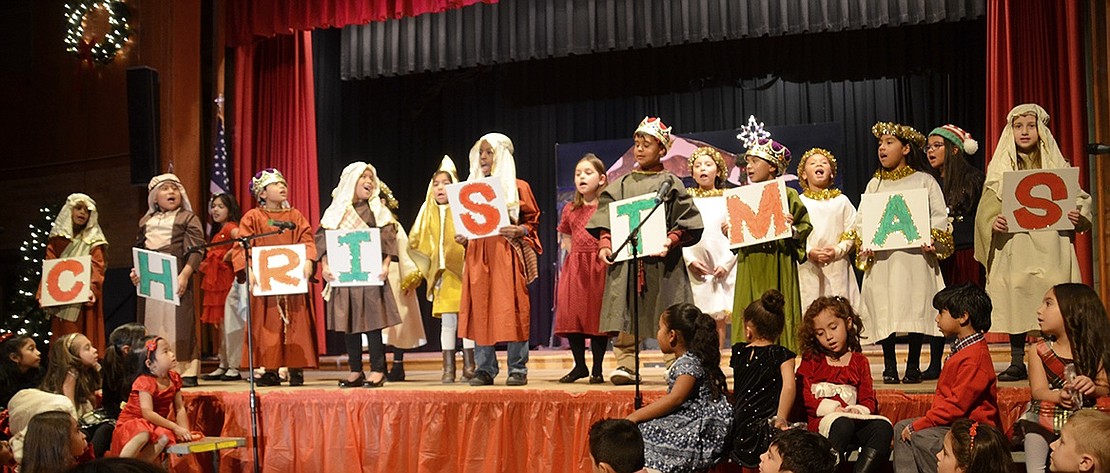 During the grand finale of Corpus Christi-Holy Rosary School’s pre-kindergarten to second-grade Christmas play, the second graders spell out and explain the meaning of Christmas with an acrostic poem in the school auditorium on Friday night, Dec. 15. 
