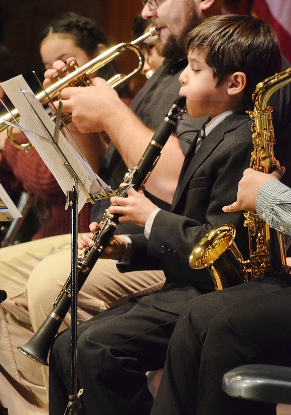 As the only clarinetist on stage, nine-year-old Dylan Cabrera focuses on his armature and sheet music during the concert. 
