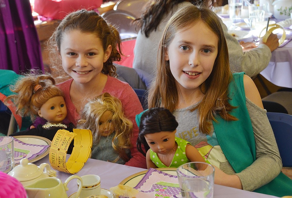 The tables are completely occupied with Girl Scouts and dolls. Port Chester residents Shea Hollwedel (right), 10, and 9-year-old Saylor Desimone spend quality time with their dolls Nanea, Tenney and Sasha. 
