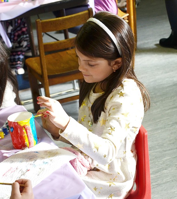Six-year-old Park Avenue School student Sophia Alonzi is pleased with her rainbow striped mug. 