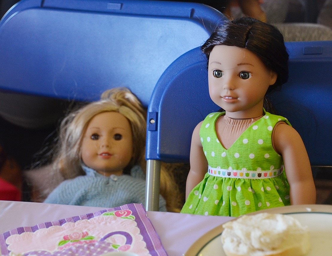 Some American Girl dolls wait patiently for their owners to return from playtime. 