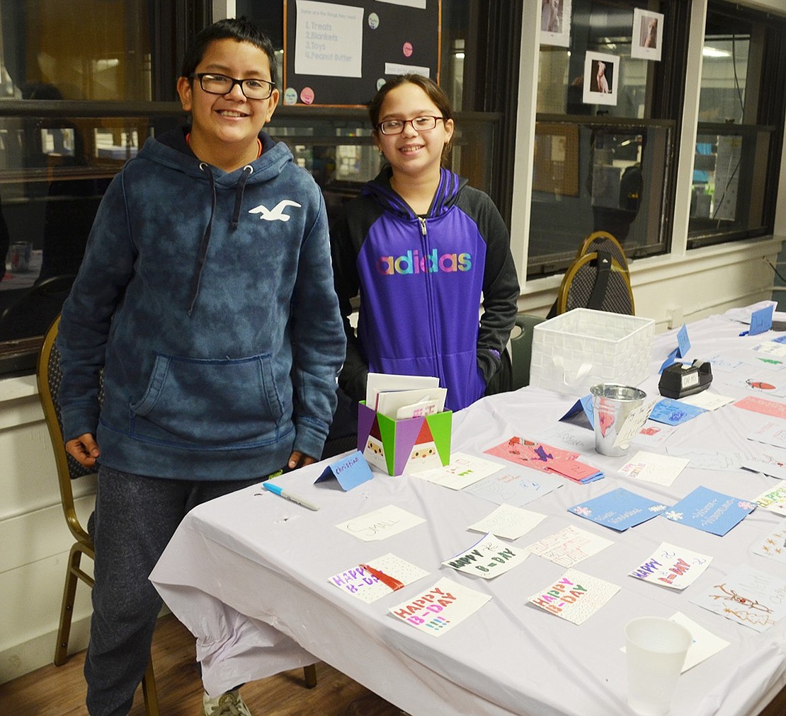 Sharing their love for animals, Christen Flores and Alexandra Trejo, 11-year-olds at Port Chester Middle School, sell valentines to raise money for the Humane Society. 