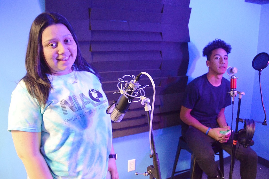 Seventeen-year-old Nicole Hernandez and 14-year-old Pedro Silva record their first podcast together in the teen center sound studio. 