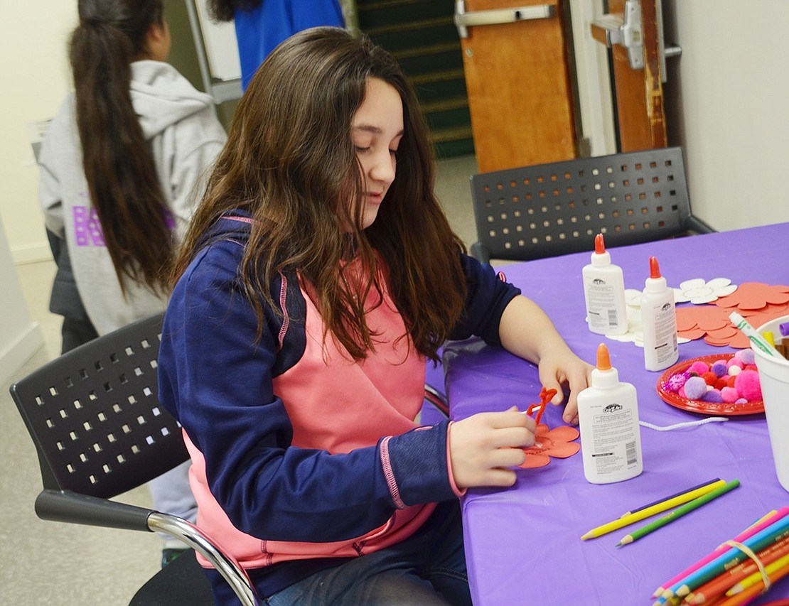 Elana Rivera, 11, is working hard on a valentine that will be delivered to senior citizens at Carver Center’s Senior Breakfast in February. 