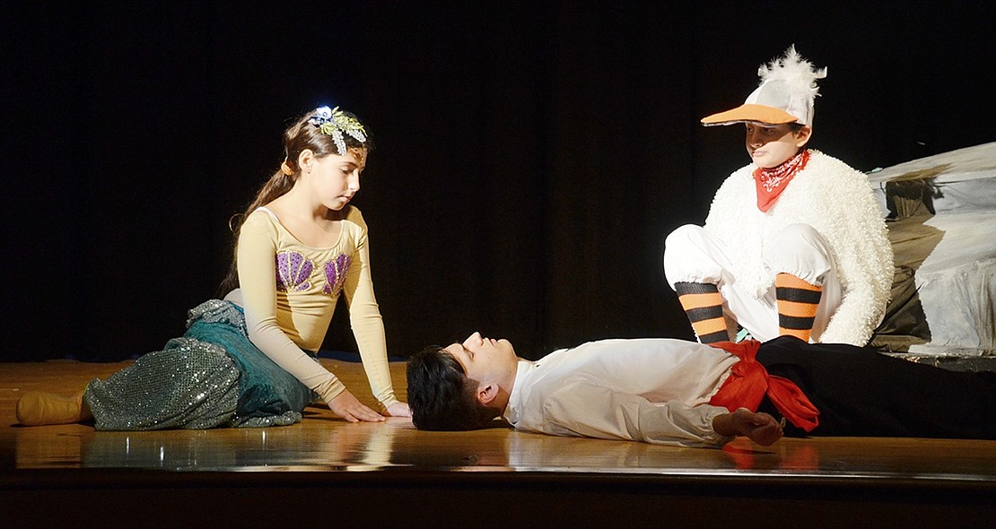 After a hurricane throws Prince Eric, played by Matthew Weinstock, off a ship, Ariel, played by Cassidy Wohl, tries to save him with her friend Scuttle the seagull, played by Corey Schiz.  