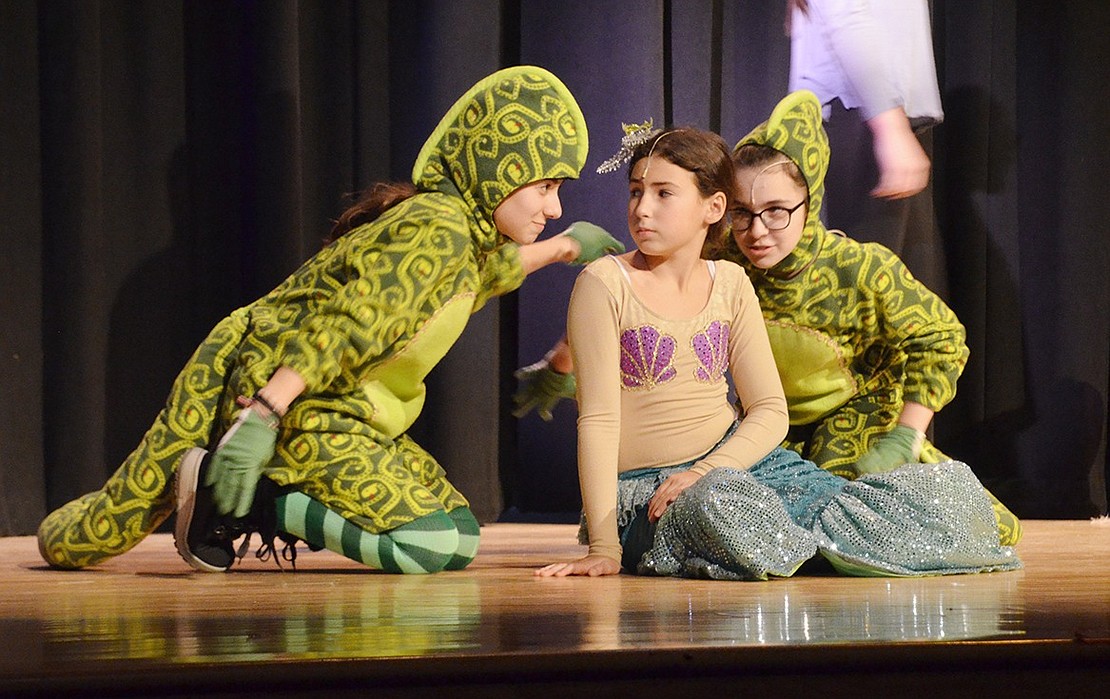 Ursula’s eels Flotsam and Jetsam, played by Arianna Chiappini and Barbara Bonfim, work to con Ariel, played by Cassidy Wohl, into a deal with the sea witch.  