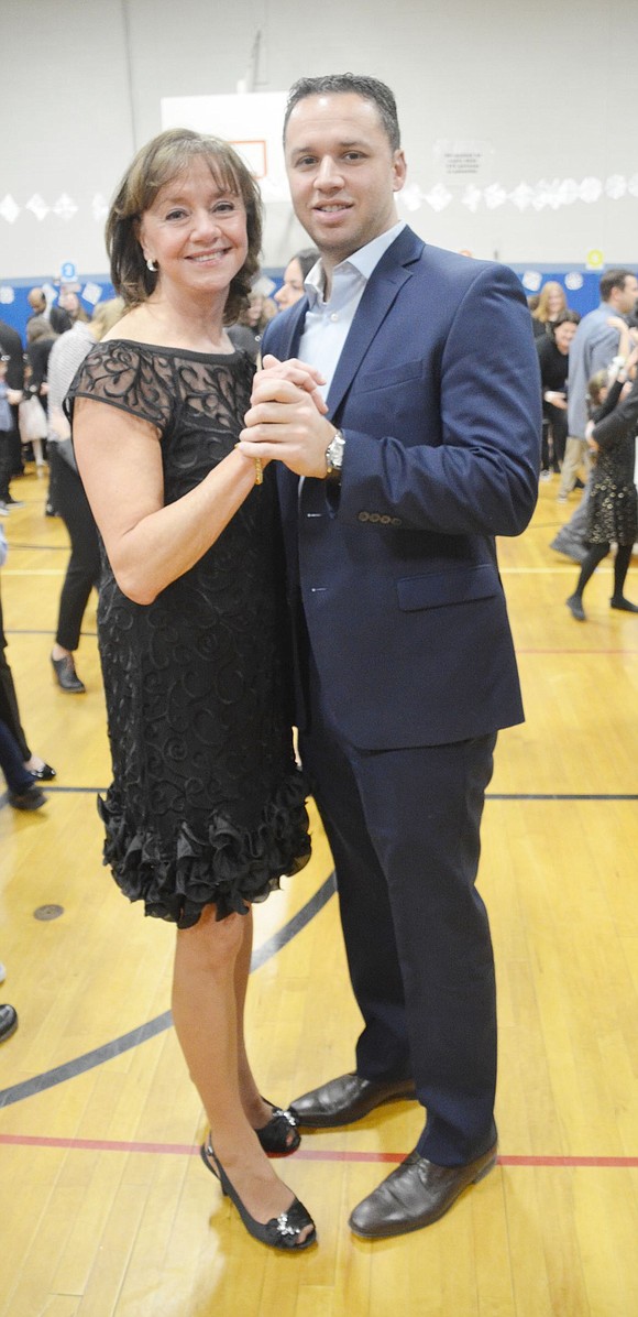 Snowball organizer Linda Greco dances with her soon-to-be married son, Christopher. This is the 28th annual Snowball Greco, who has been with the district for 30 years, has put on.   