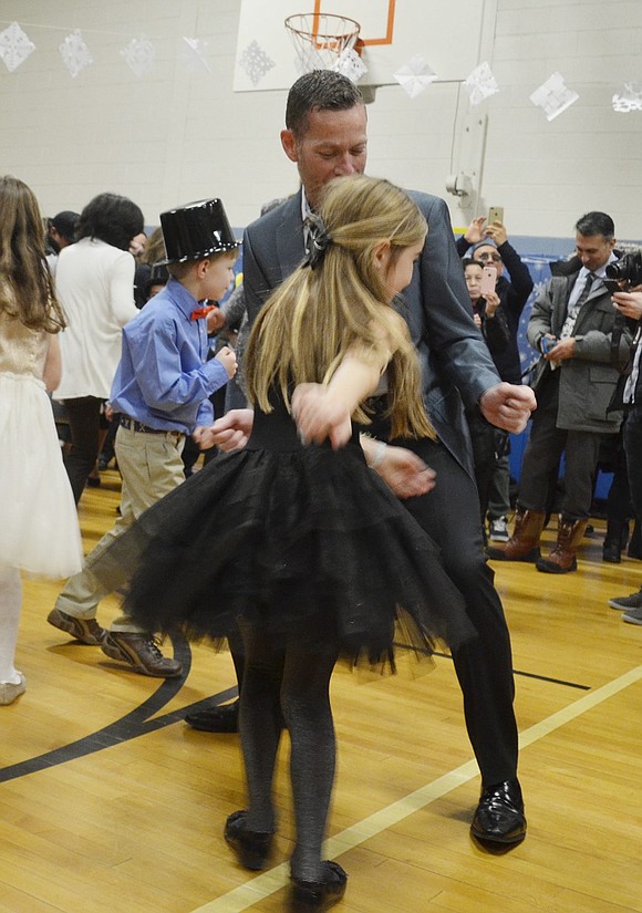 Hayden Sassower and her father pull some groovy dance moves while they do the twist.  