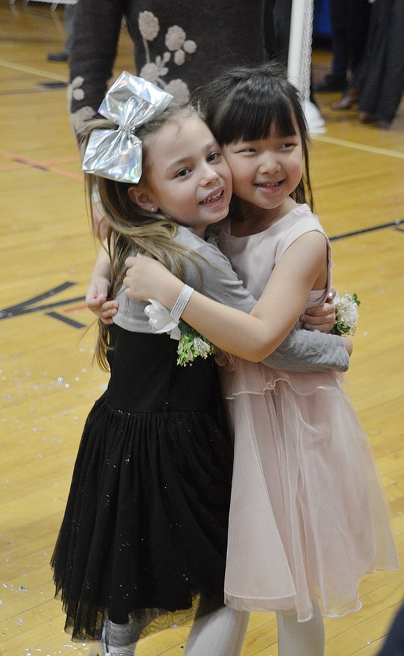 Kylee Zhang (left) and Serena Tremble show some love after the performance