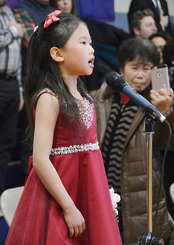 Second-grader Maggie Miao kicks-off the Snowball by singing the National Anthem to the crowd.