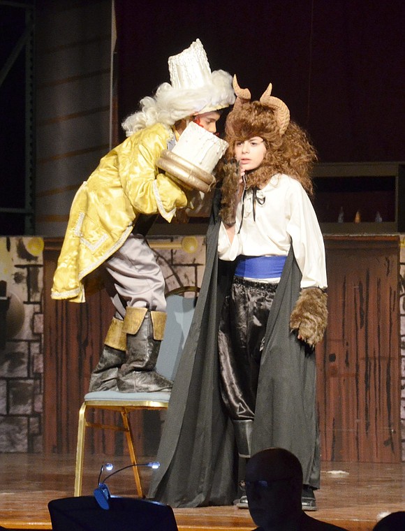 Desperate to become human again, Lumiere, played by Ivan Lopez, gives the Beast advice on how to woo Belle. The Beast is played by Michael Perrone. 