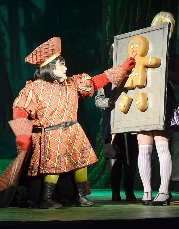 Lord Farquaad (played by Lee Price) tortures the Gingerbread Man (played by Julia Short) to get more information about Princess Fiona. 