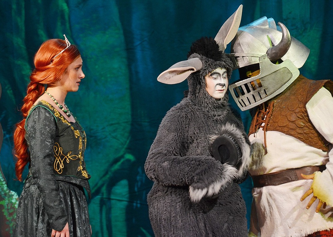 Donkey (played by Justin Levine) tries to give Shrek (played by Michael Lieberman) advice on how to treat the unsatisfied Princess Fiona (played by Emily Zeller). 