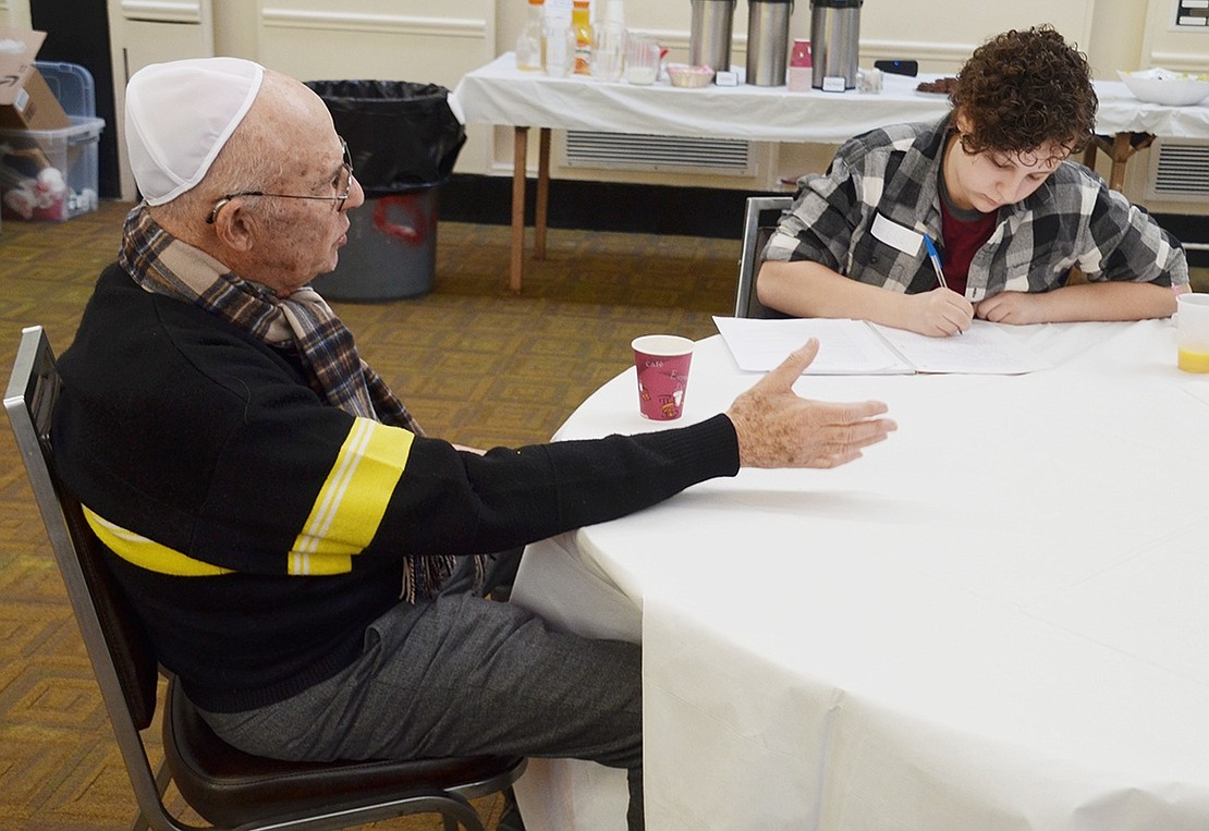 As a Holocaust survivor who escaped through France, Armonk resident Daniel Vock shares his story while 15-year-old Rye Brook resident Peri Glick takes notes. She is interviewing Vock for the second wave of an oral history project started by Abe Baker-Butler in 2015 because, as Baker-Butler questions, “when these people are gone, how will we hear their stories?”