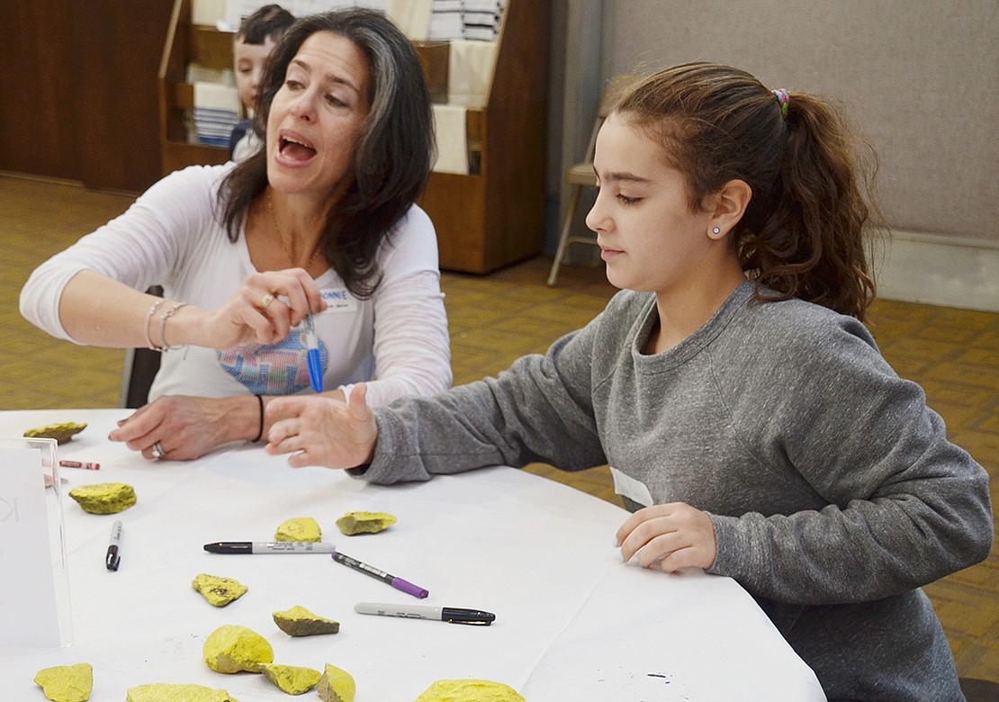 Rye Brook resident Bonnie Baker-Butler and her 12-year-old daughter, Anna, work together to color kindness rocks. 