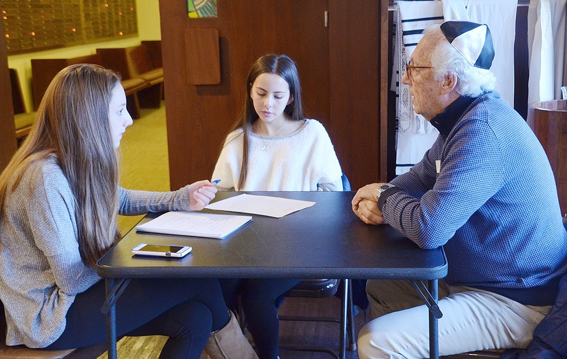 Emma Margolis (left) and Abbie Wolkind ask David Rosen of Rye Brook to compare how Jewish education is different now than when he was a child. 