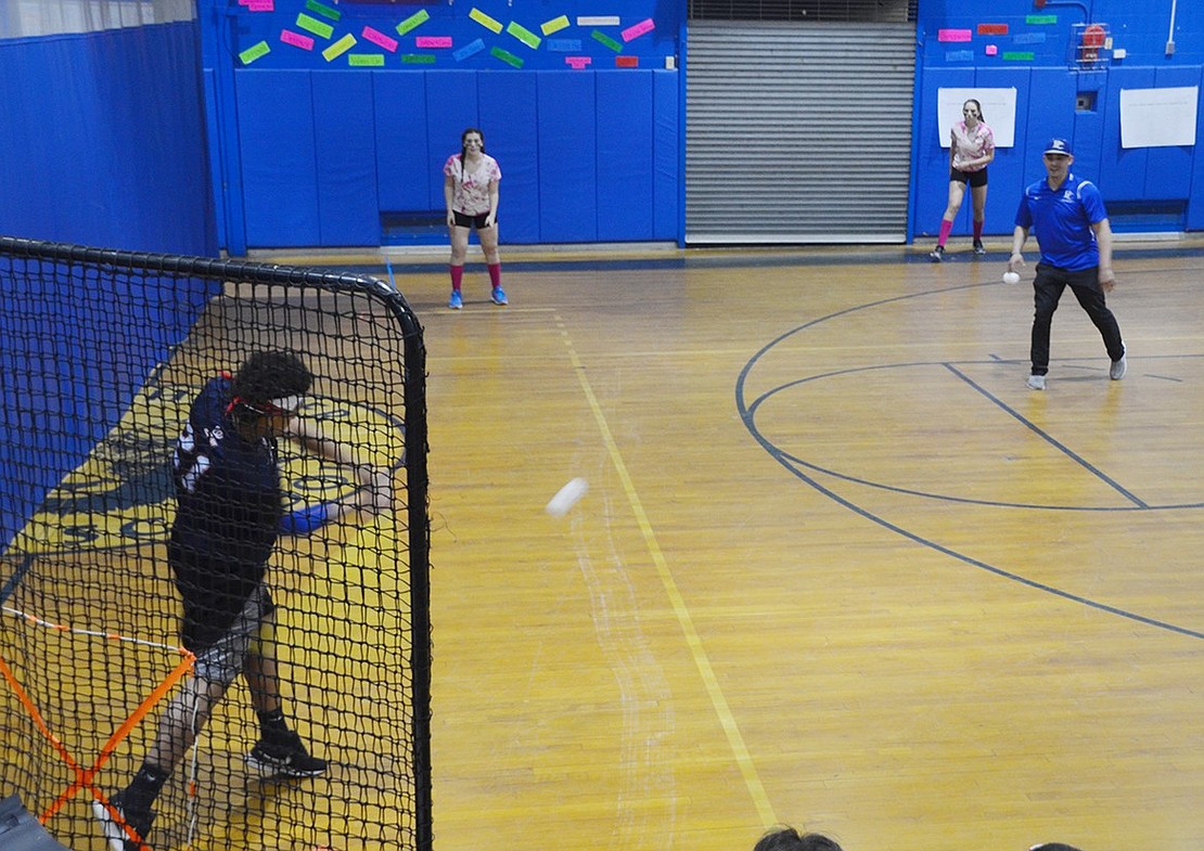 Francis Paredes hits a home run for the Port Chester High School sophomore “Sons of Pitches” team during the annual Port Chester Baseball Booster Club Wiffle Ball Tournament on Friday, Mar. 9, in the Port Chester Middle School gymnasium.  