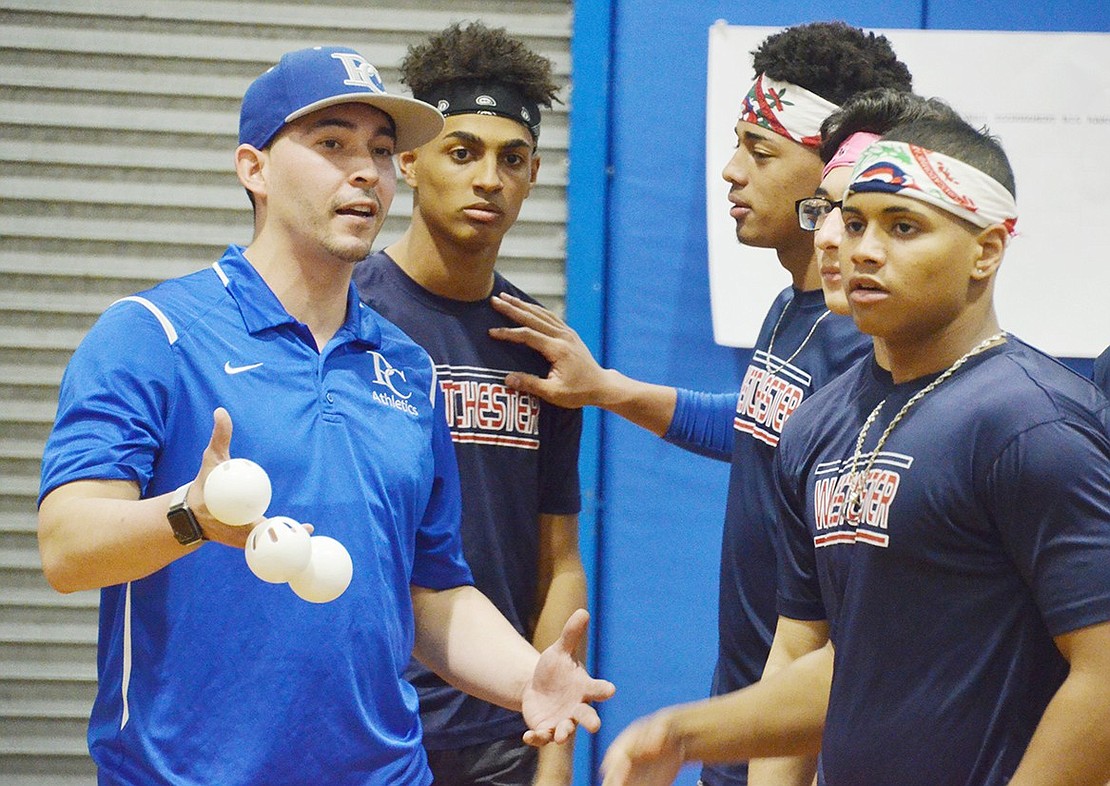 “Sons of Pitches” members chat it up with the pitcher, varsity baseball coach Eddie Martinez, before their next inning. 