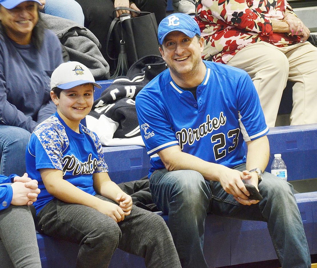 Steve Borzoni bonds with his son John Borzoni, a Park Avenue Elementary School fifth-grader on the “Swing and a Wiff” team, over the ball game. 