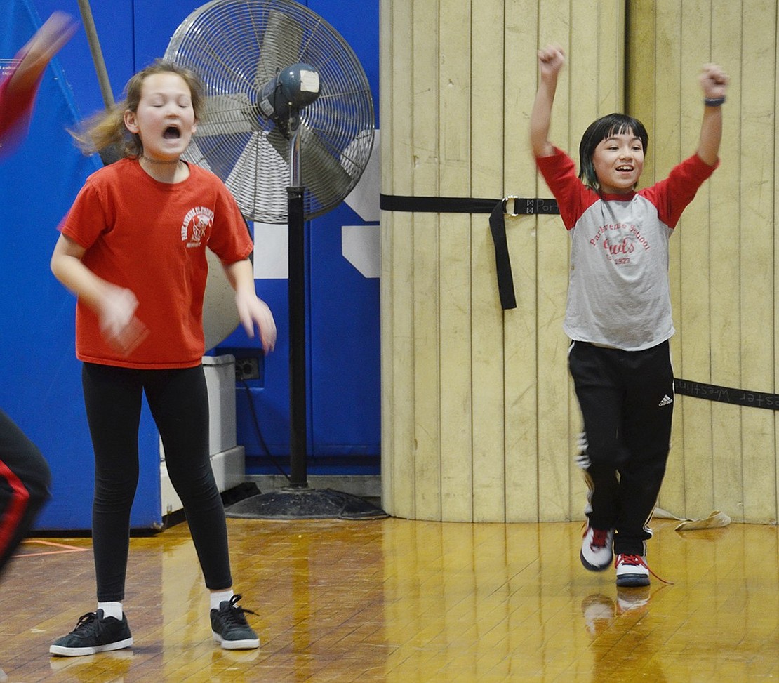 After a great play by Park Avenue Elementary School fifth-graders, Morgan Saunders (right) and Cameron Caie cheer for their team on the court. 