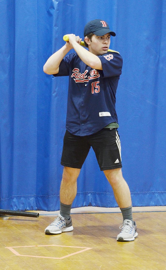 Port Chester High School sophomore Justin McFadden prepares to whip the Wiffle ball across the gym. 