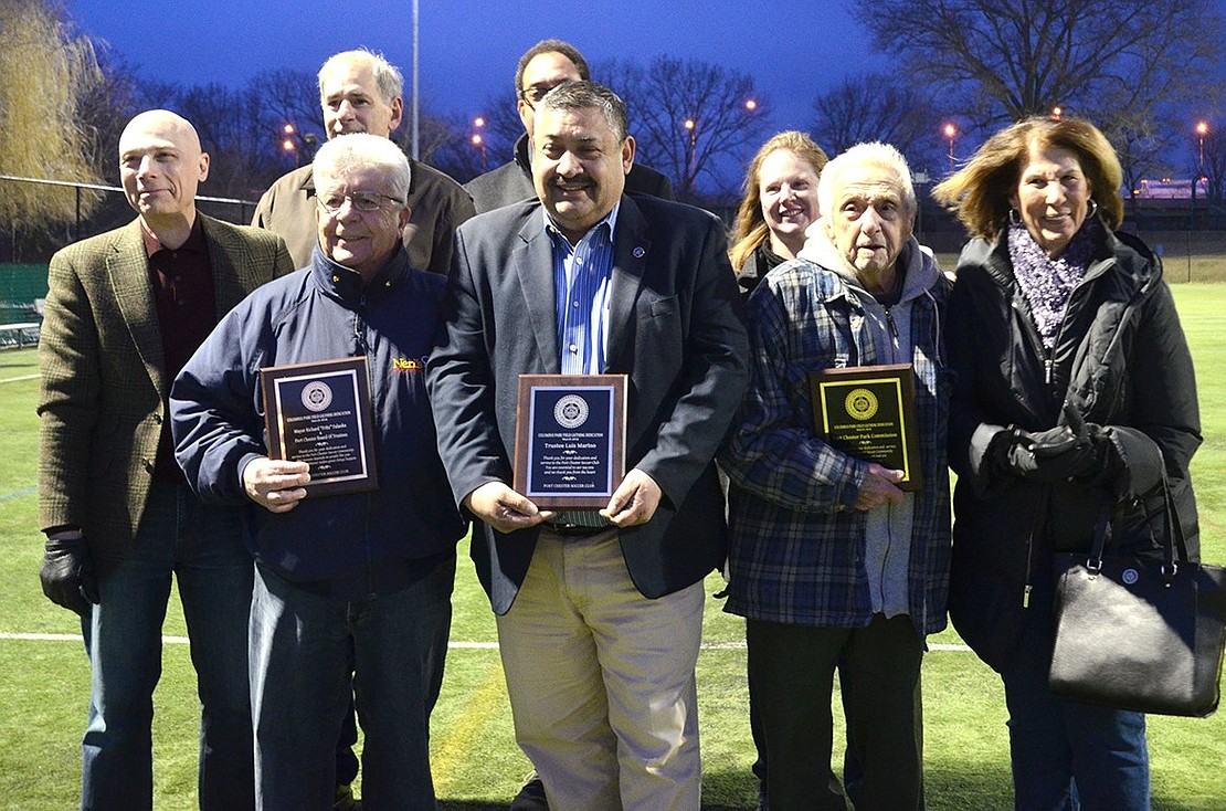 Port Chester Soccer Club officers Aaron Guerrero and David Hidalgo presented plaques to Mayor Richard “Fritz” Falanka (left) and the Board of Trustees, Trustee Luis Marino (middle) and the Port Chester Park Commission, accepted by Jerry Terranova (right) and Connie Thalheimer, thanking them for their roles in getting the lights. Also pictured are, back row, from left: Trustees Frank Ferrara and Gene Ceccarelli, Village Manager Chris Steers and Recreation Supervisor Heather Krakowski. Jananne Abel|Westmore News 
