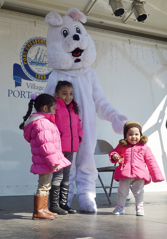 Even though 1-year-old Vivian Carias keeps trying to run away, she stands still for a second to meet the Easter Bunny (played by Dawn DeLeo) with her sister, 7-year-old Park Avenue School student Evolett and Port Chester Head Start 4-year-old Arianny Lopez. They came to Lyon Park to celebrate Easter in the Park on Saturday, Mar. 24. 