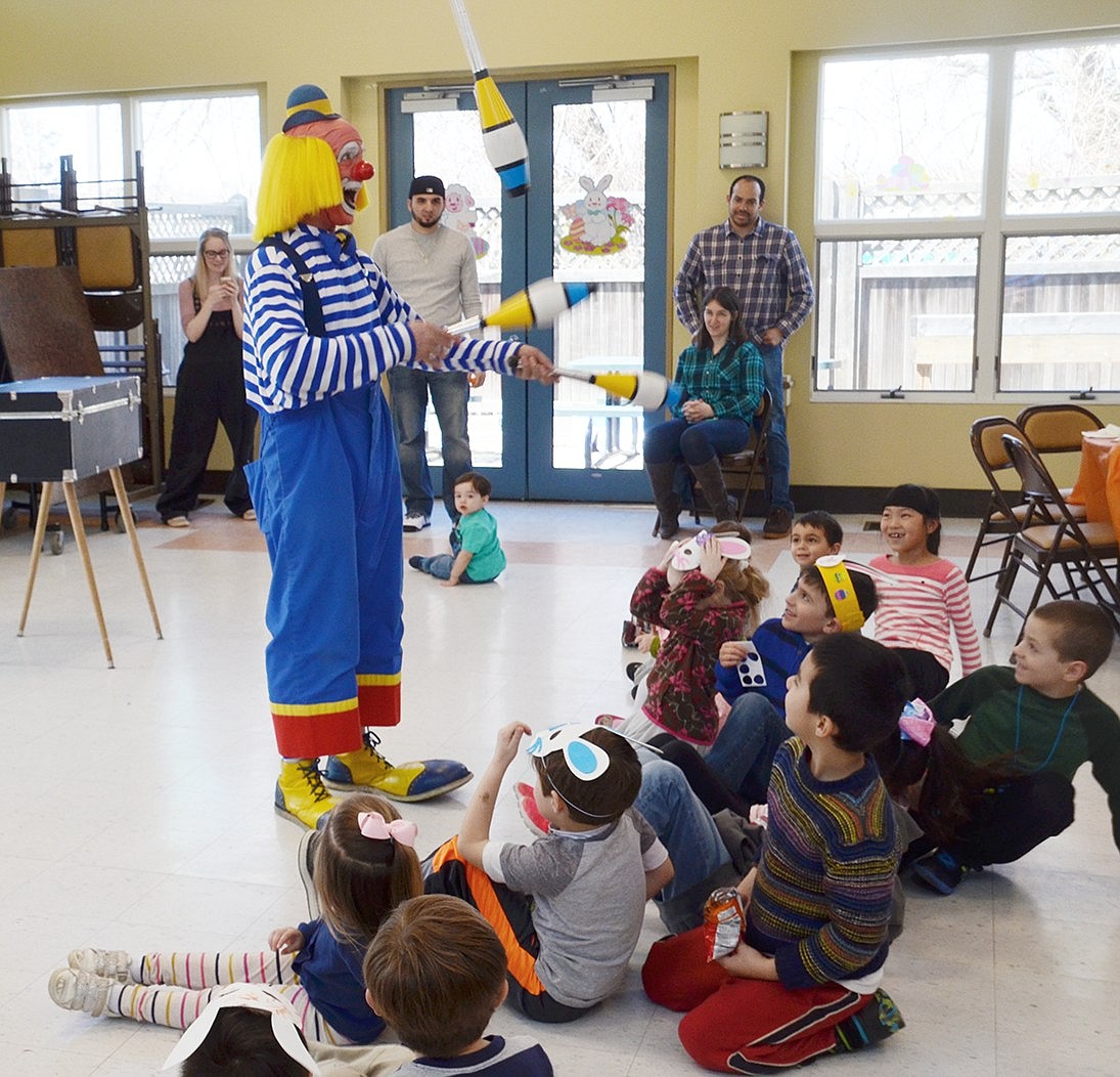 Trying not get bonked on the head, a group of children slowly back up as Macaroni the Clown (played by Tom Mayes) inches closer and closer while juggling clubs during Lunch with the Bunny on Saturday, Mar. 24 at the Anthony J. Posillipo Community Center at 32 Garibaldi Pl.   