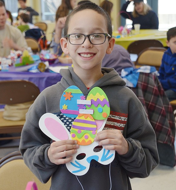 After adding some final touches, Roanoke Avenue resident Anthony McClendon, 8, shows off his bunny mask. 