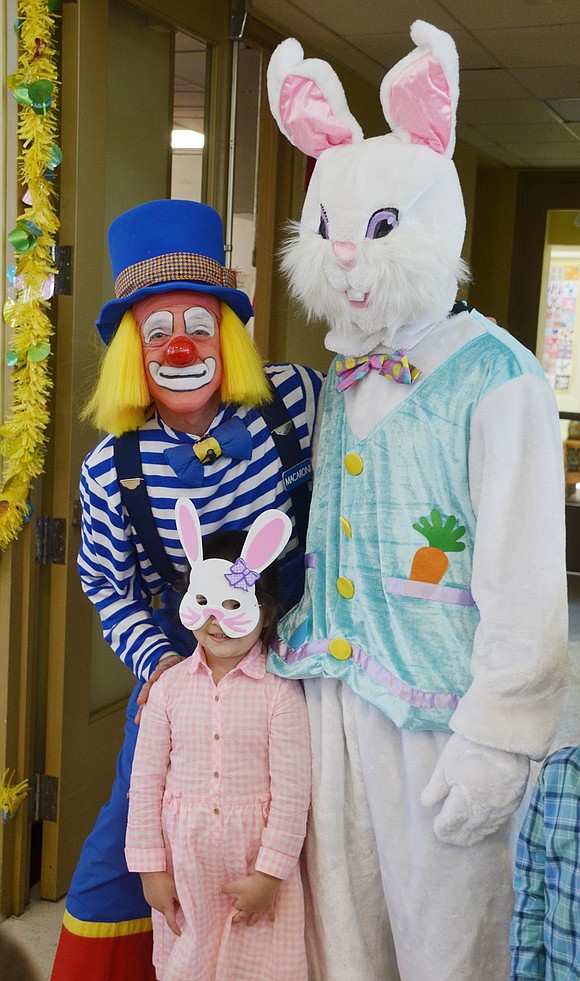 Amelia Zuccarelli, a 4-year-old Avon Circle resident, smiles for the camera with the Easter Bunny (played by Blind Brook High School senior Daniel Oppizzi of Betsy Brown Road) and Macaroni the Clown. 