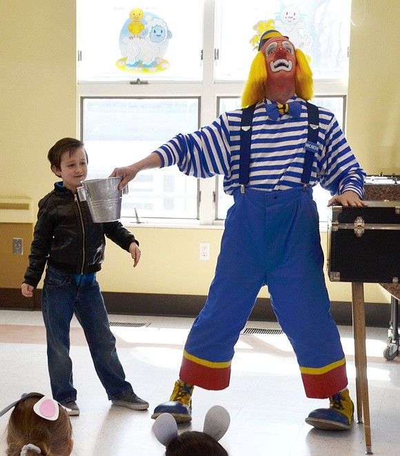 Macaroni the Clown just can’t figure out where 8-year-old Jean Lane resident Quinn Borzoni is finding so many coins to drop in his bucket. 