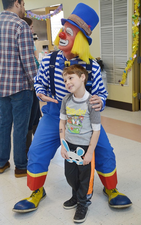 Macaroni the Clown strikes a goofy pose with 6-year-old King Street resident Luke Pallotta.