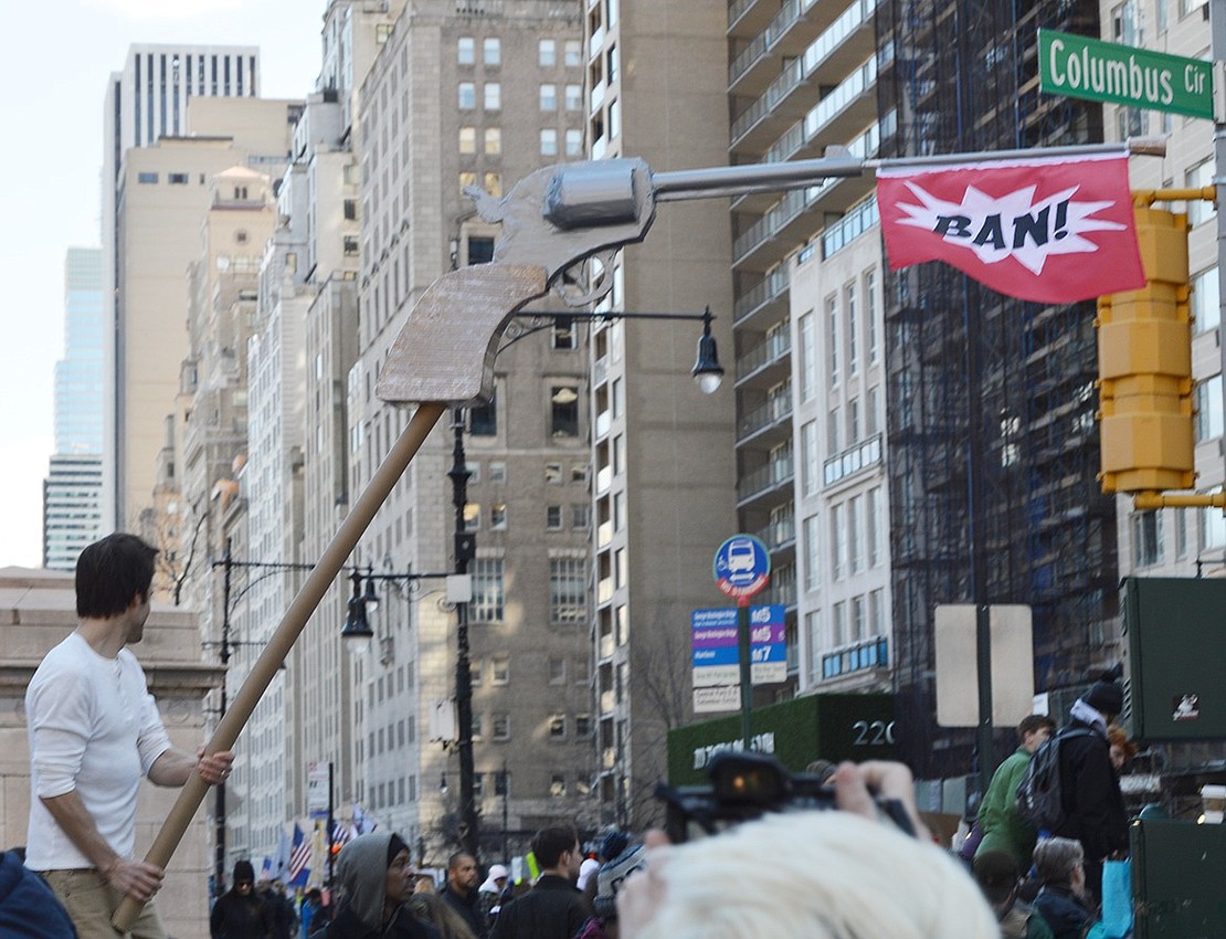 Demonstrators use a large gun prop at the NYC rally as a metaphor for their frustrations regarding gun laws in the U.S. Noah Zeitlin|Westmore News 