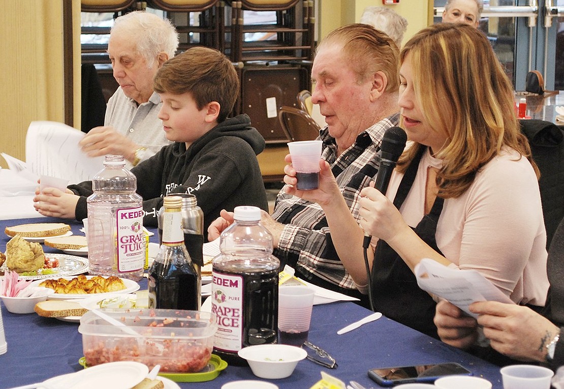 Elizabeth Rotfeld, Rye Brook Seniors coordinator, leads the room in prayer before drinking the fourth cup of wine, symbolizing Jewish rededication to freedom, during the Passover Seder at the Anthony J. Posillipo Community Center at 32 Garibaldi Pl. on Tuesday, Apr. 3.        