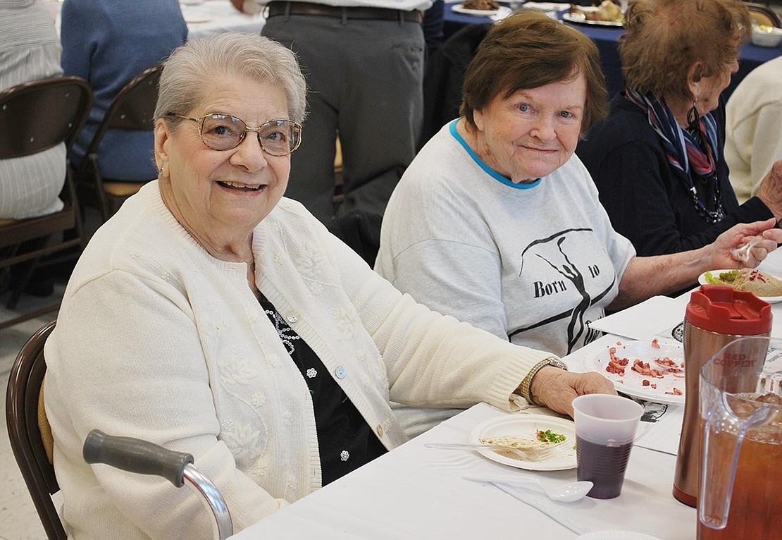 Joan McGrath Greve (right) and Anna Amaturo, Louis Court friends and neighbors, are happy to enjoy their gefilte fish together at the Seder.