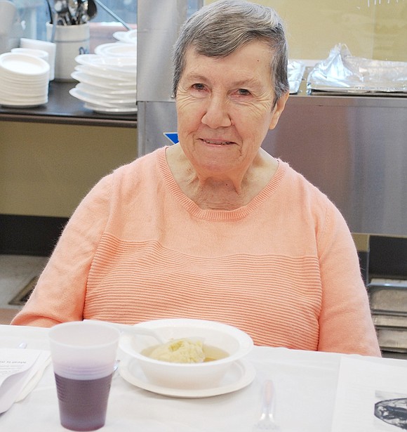 King Street resident Marie Cacace takes a short break before finishing her matzo ball soup. 