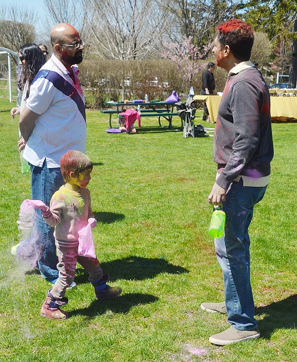 Unsuspecting father Ajay Natrajan chats with a friend, unaware he’s about to get blasted with pink by his 3-year-old son Dev. They live in BelleFair. 