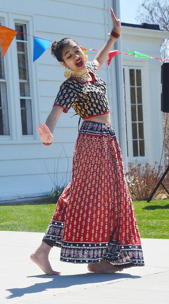 Wearing a ravishing dress, Stamford, Conn. eighth-grader Rhea Bhat performs traditional Indian dances in celebration of Holi.