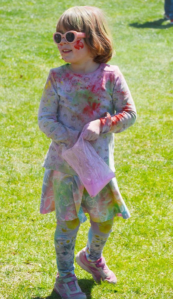 In her appropriately colorful outfit and groovy sunglasses, Sleepy Hollow Road resident Sarah Craighead, 4, seeks her next color blast attack victim. 