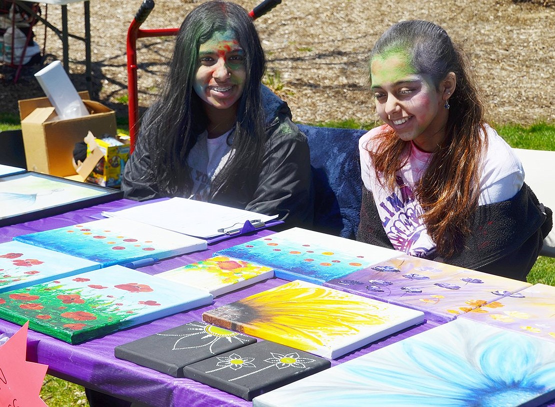 Blind Brook High School freshman Komal Samrow (right) and eighth-grader Archana Kumaran man the silent auction table featuring dozens of pieces of art. All proceeds from the Color Blast event were donated to Pancreatic Cancer Action Network to advance cancer early detection efforts. 