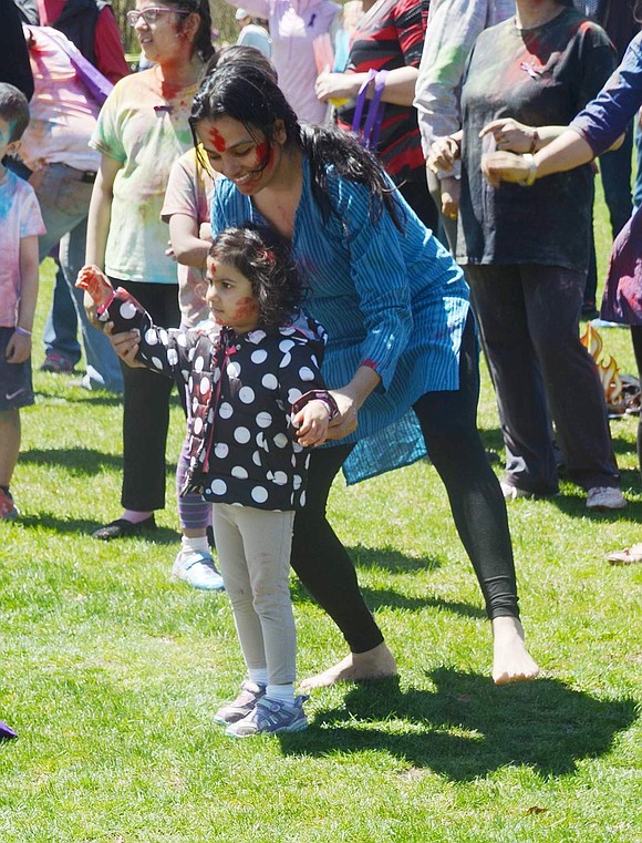 Visiting from Bronxville, Tanu Kothari dances with her 3-year-old daughter Aranya. 