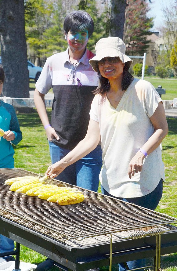 Swati Joshi and her son, Blind Brook eighth-grader Raghav, grill and serve corn on the cob for hungry festival goers. 