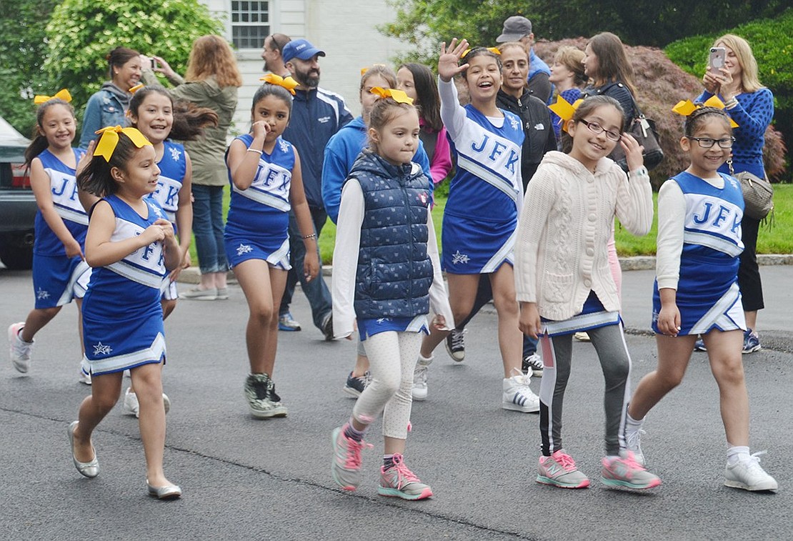 Excited to represent John F. Kennedy Elementary School, members of the cheerleading squad join the parade to celebrate 150 years since the incorporation of the Village of Port Chester. 