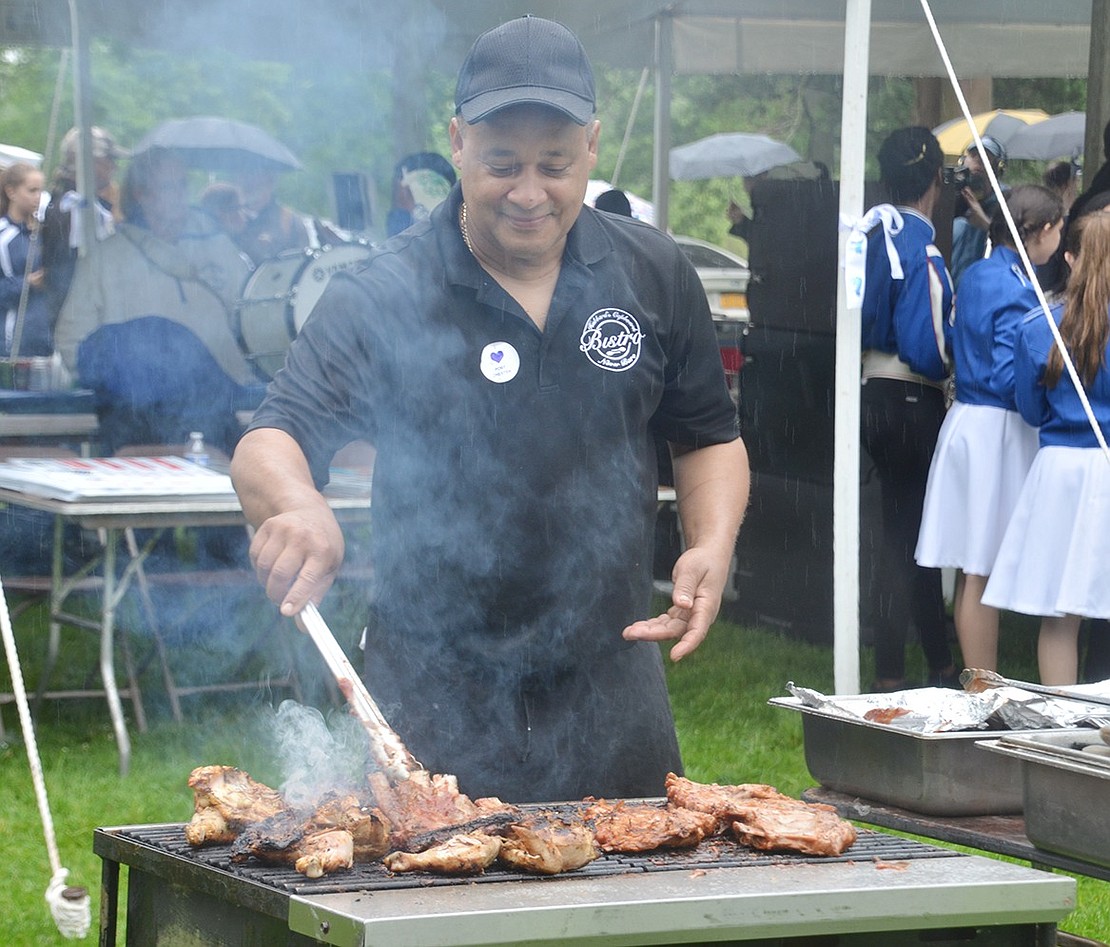 It’s not a festival in the park without a barbeque! Esmerito Henriquez from Hubbard’s Cupboard Bistro on North Pearl Street cooks various meats on the grill behind the vendors. 