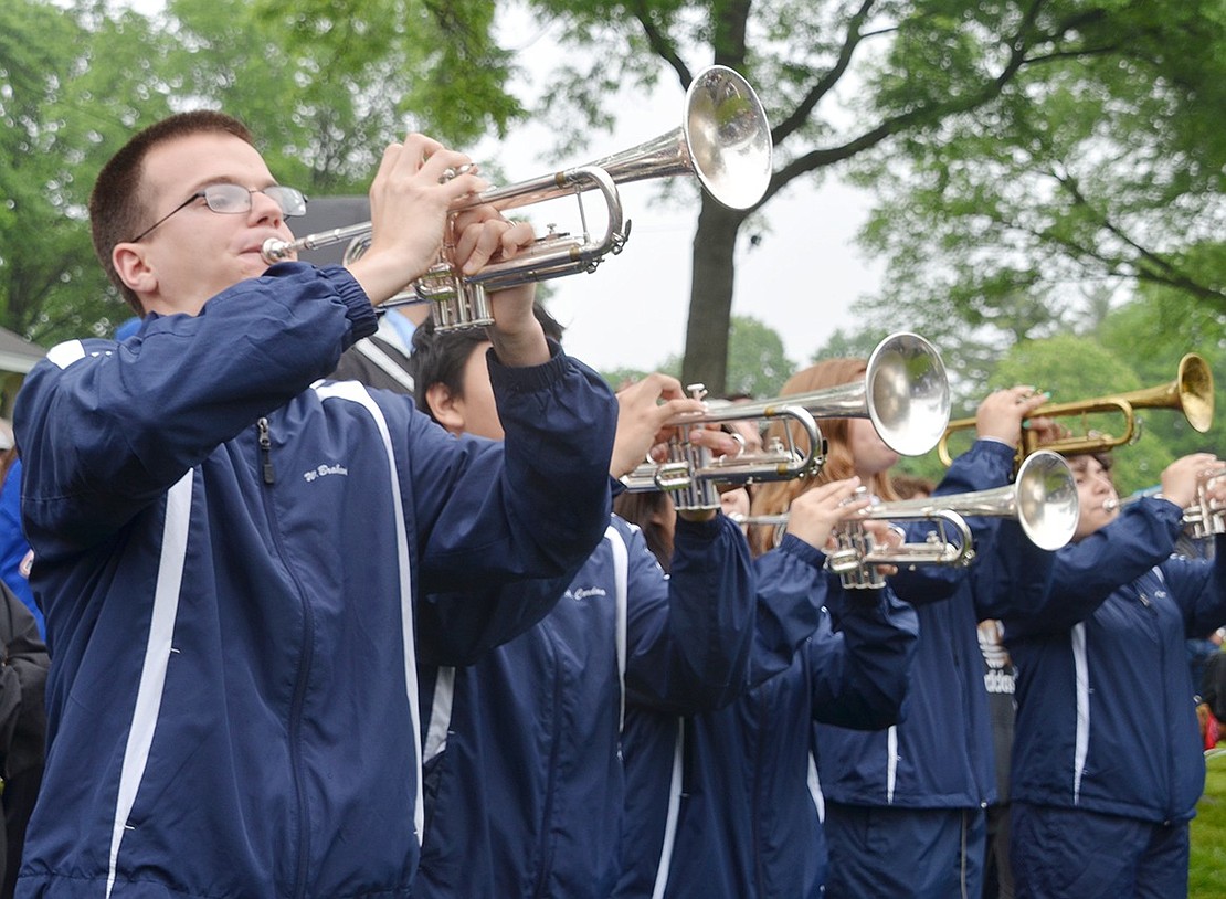 Leading the trumpet section, Port Chester High School senior William Brakewood performs a solo on his horn after the PCHS Band marches into the park. 