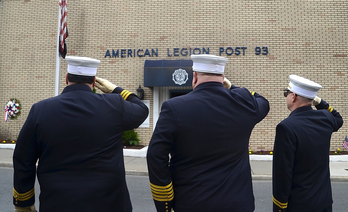 Port Chester Fire Chiefs Enrico Casterella, Michael DeVittorio and Herbert Bocchino salute during a ceremony in front of American Legion Post 93 on Pearl Street.