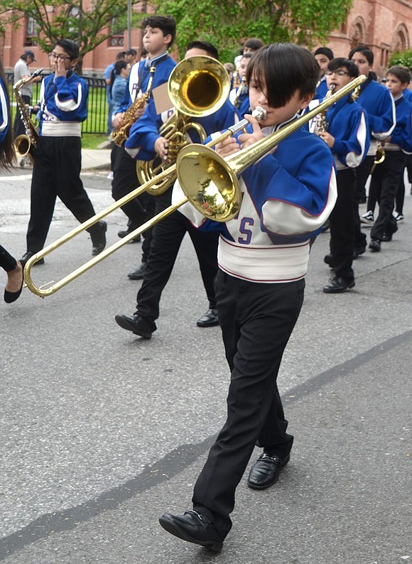 Anthony Monroy plays trombone in the Port Chester Middle School 6th Grade Band as it marches down the avenue.