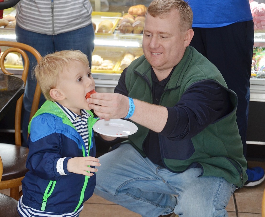 Washington Mews resident Tim Malin treats his 4-year-old son, Brian, to a sweet Colombian baked good at Asi Es Colombia at 172 N. Main St. 